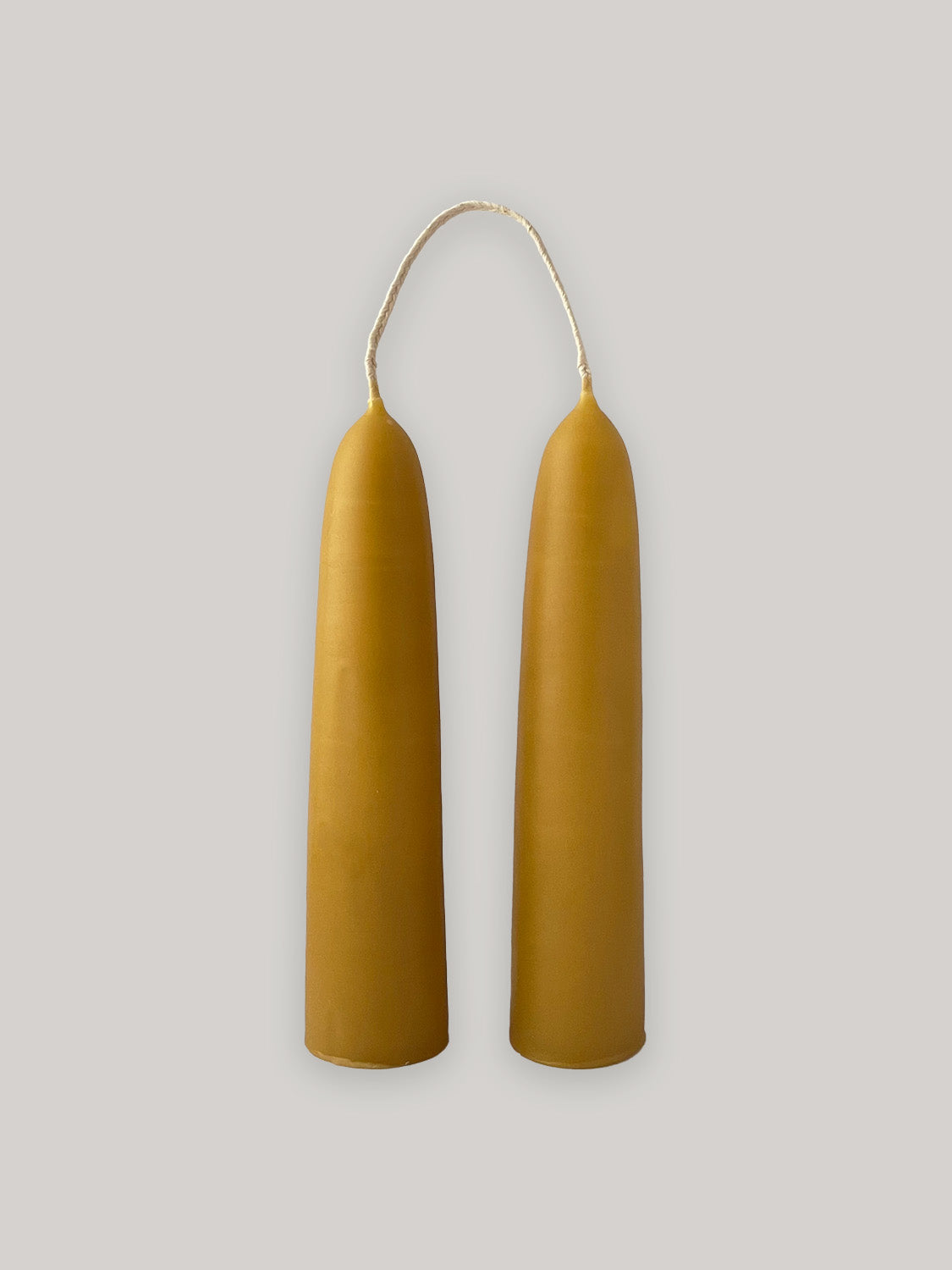 Pair of organic beeswax hand-dipped stubby candles - front.