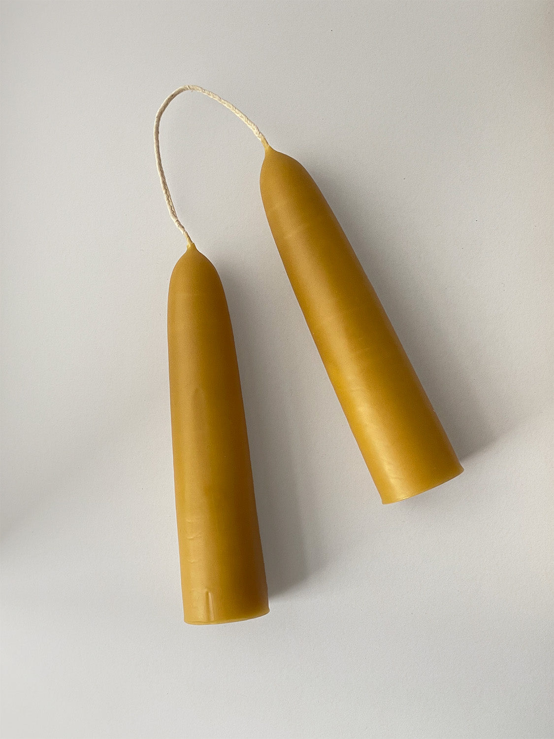 Pair of organic beeswax hand-dipped stubby candles - top.