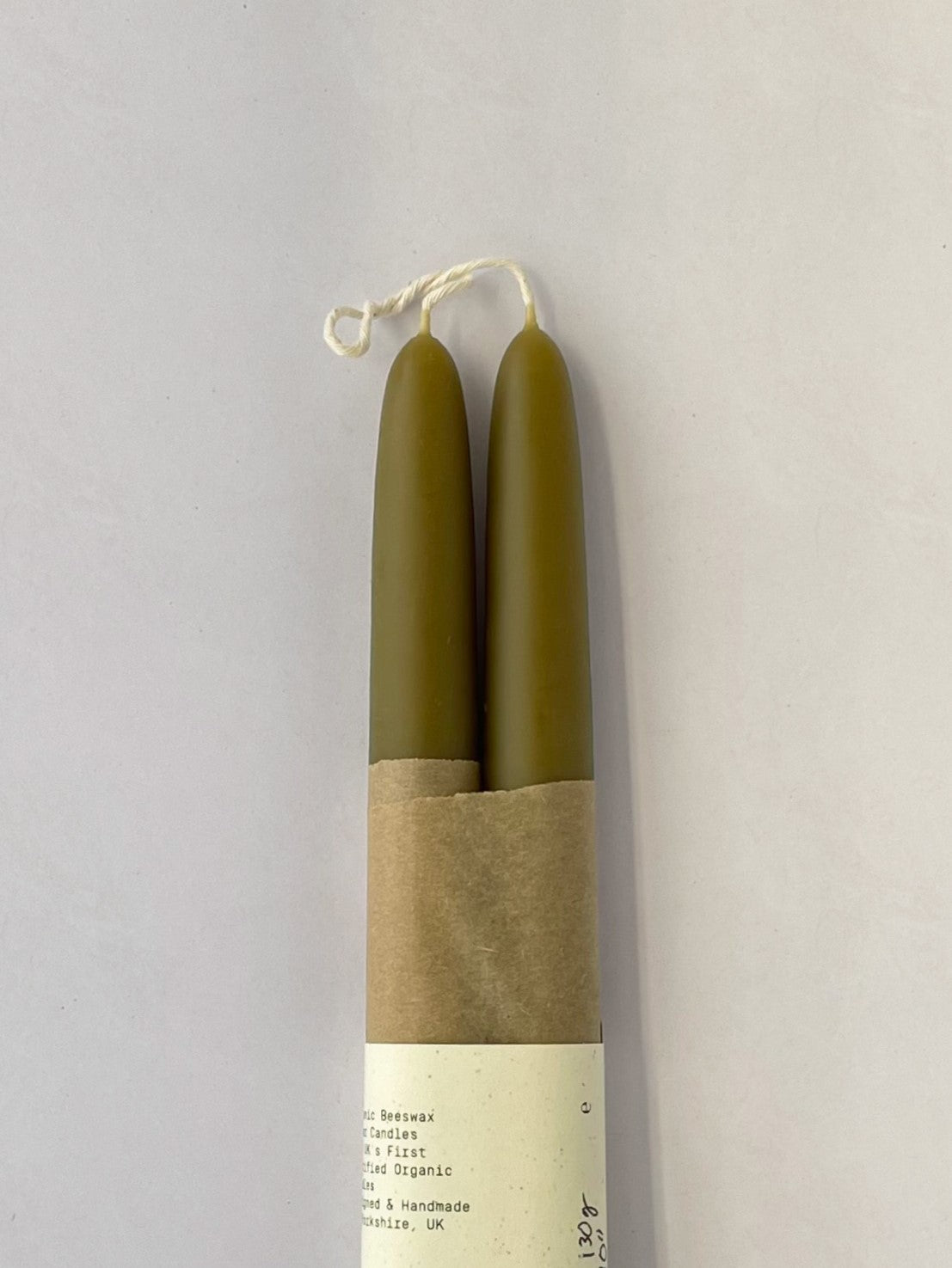 Pair of organic beeswax and green tea hand-dipped taper candles - detail.