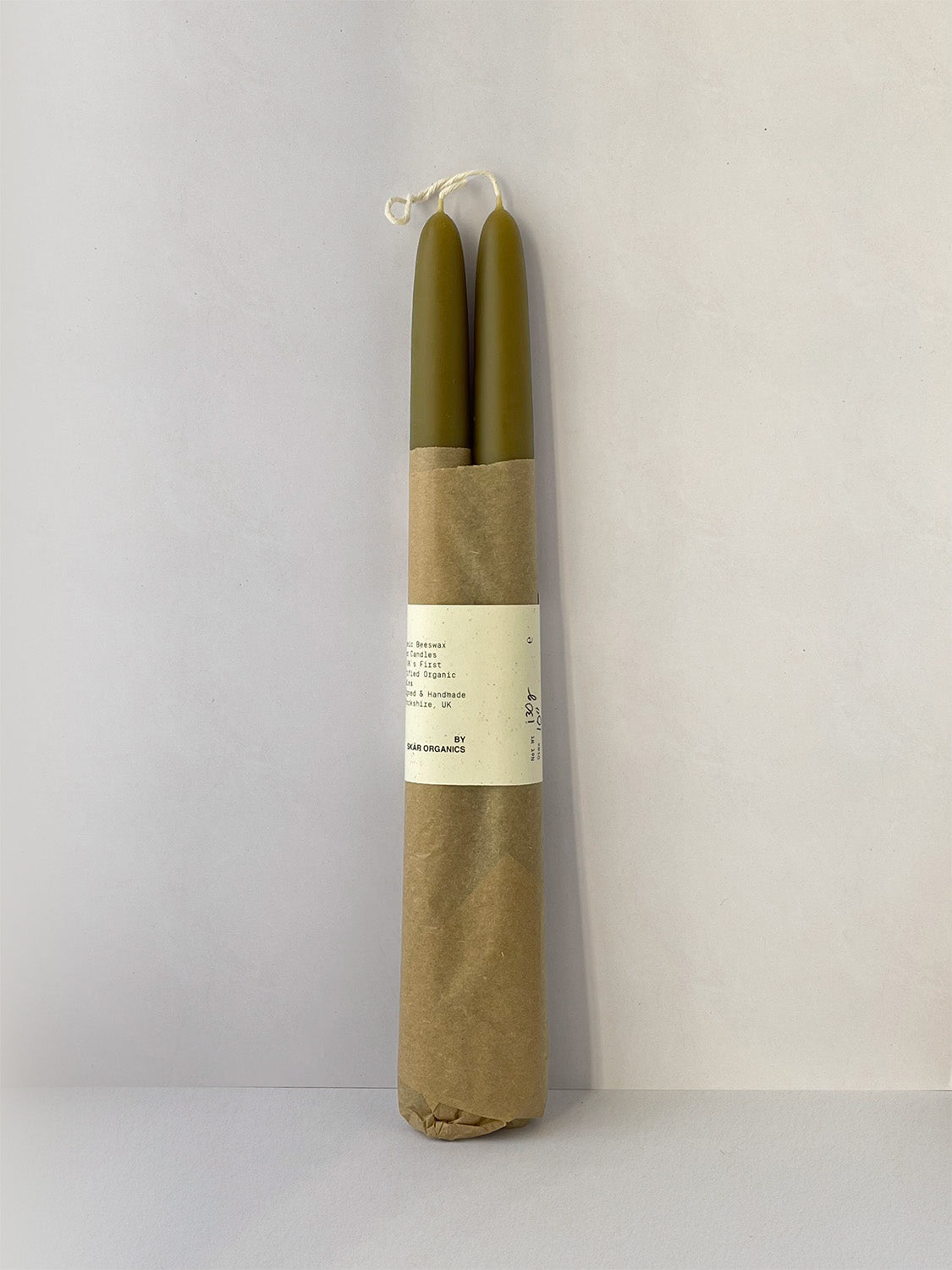 Pair of organic beeswax and green tea hand-dipped taper candles - front.