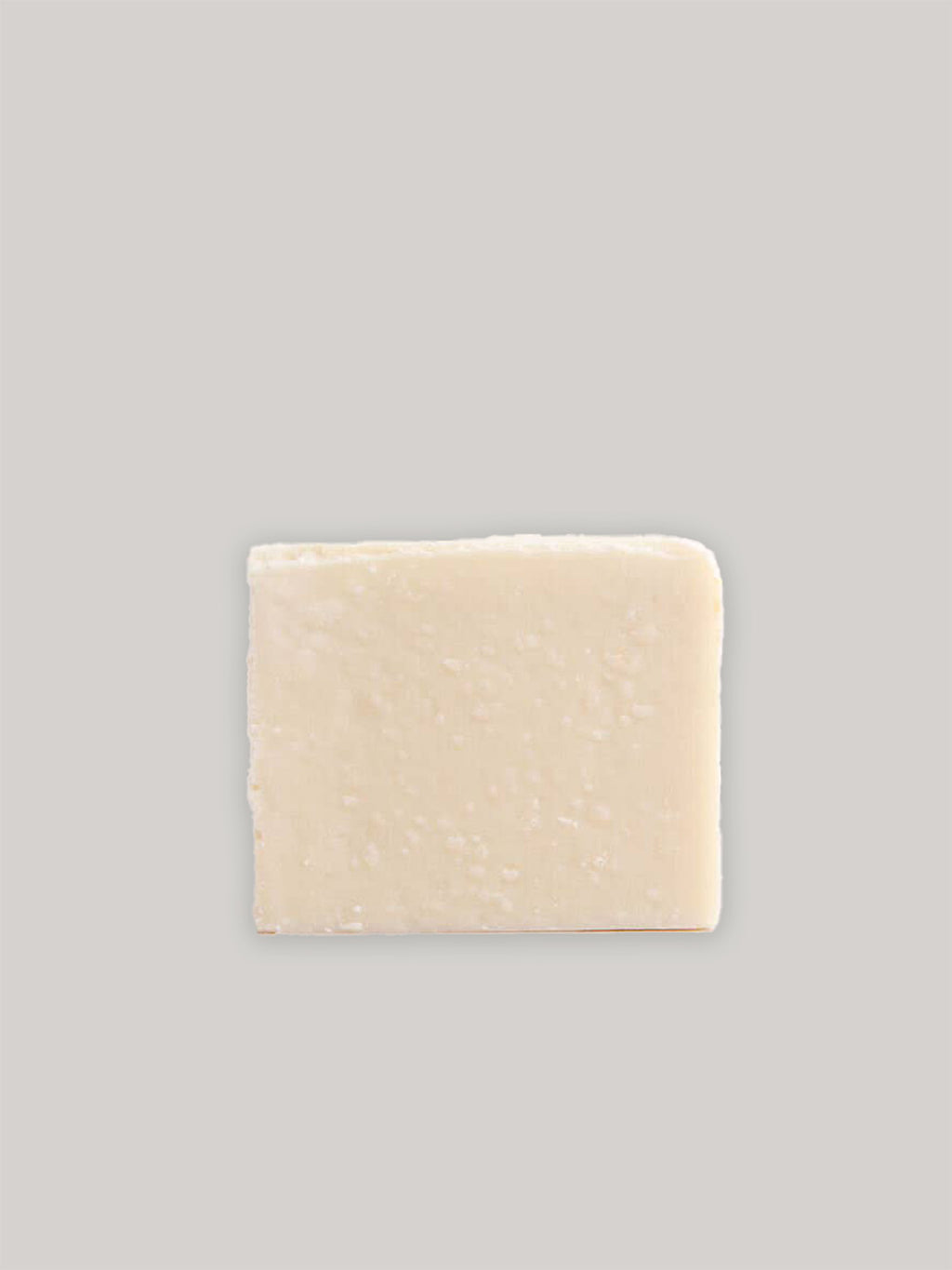 Bar of natural handmade soap on a neutral background.
