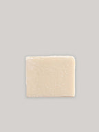 Bar of natural handmade soap on a neutral background.