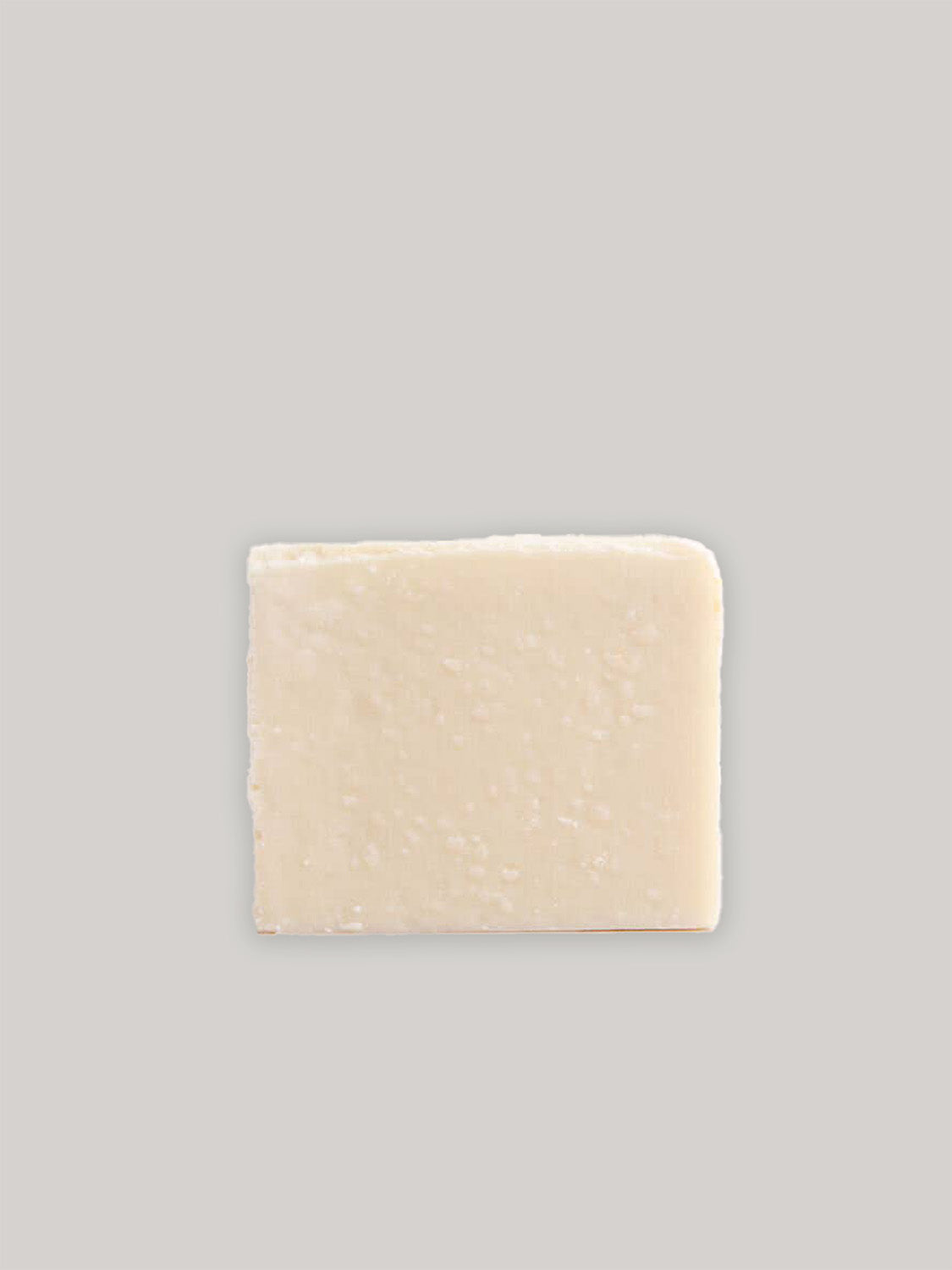 Bar of natural handmade soap on a neutral background.