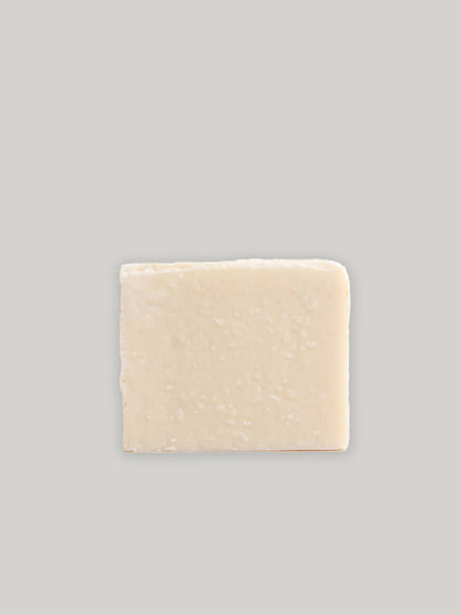Bar of natural handmade soap on a neutral background.