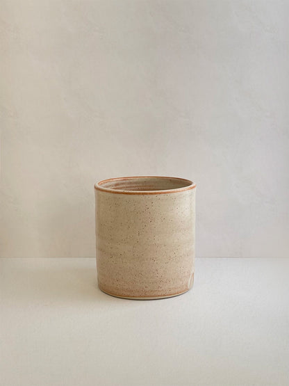 Rust ceramic mug on a neutral background - front view.