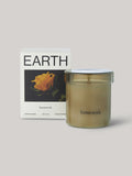 Candle labelled 'homework' with packaging featuring the word 'EARTH'.