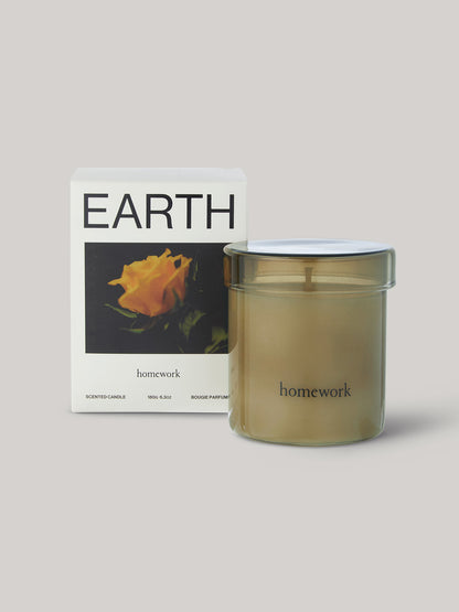 Candle labelled 'homework' with packaging featuring the word 'EARTH'.