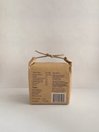 Kraft paper packaging with nutritional information on a neutral background.