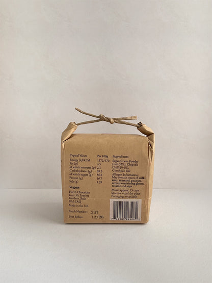 Kraft paper packaging with nutritional information on a neutral background.