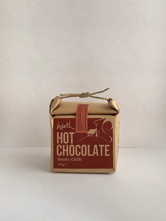 Box of hot chocolate with a red label on a neutral background.