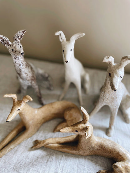 Group of five stoneware hounds.