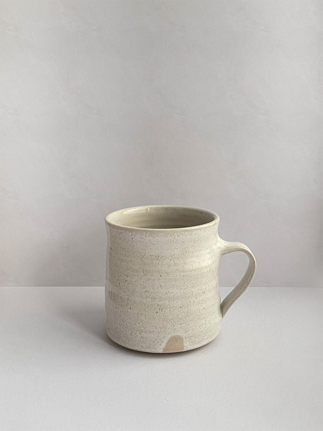 Warm White Speckle ceramic mug - front.