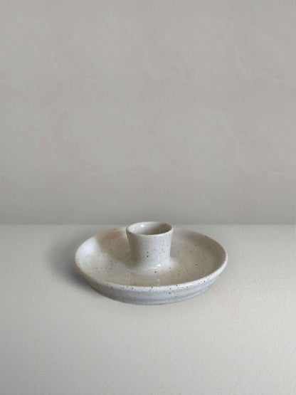 Low round ceramic candle holder in glossy white speckled glaze - front.