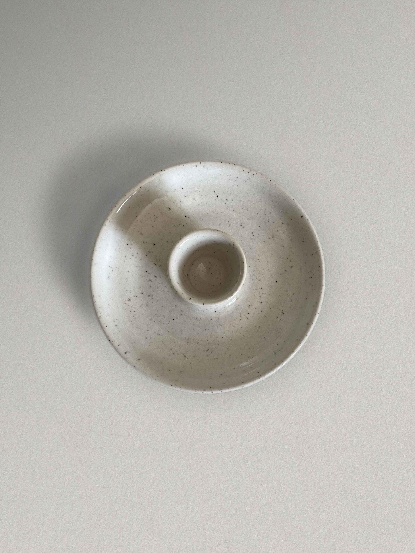 Low round ceramic candle holder in glossy white speckled glaze - top.