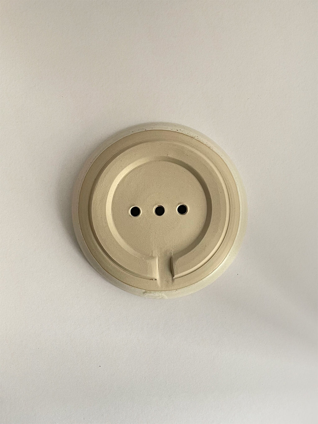 Ceramic soap dish on a neutral background - base view.