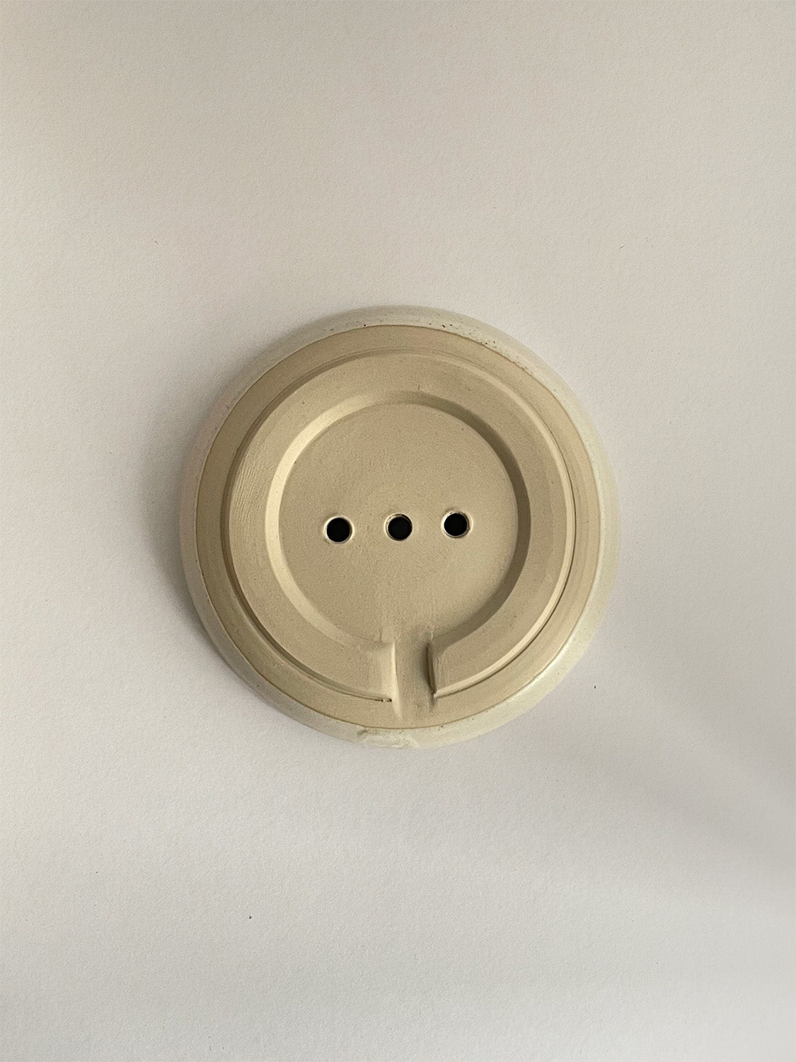 Ceramic soap dish on a neutral background - base view.