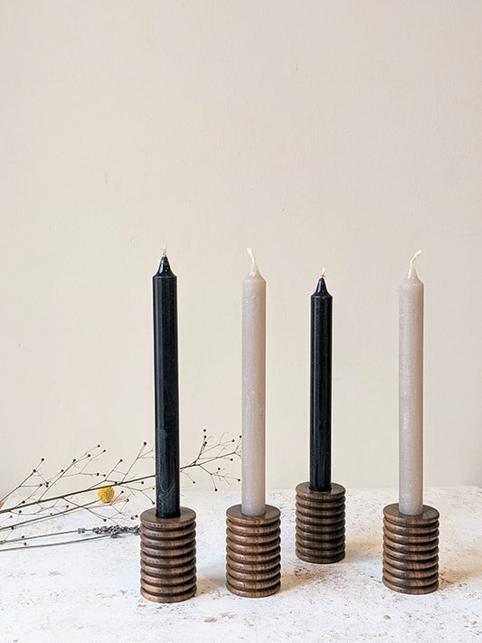 Two pairs of wooden candle holders in walnut with candles - front.