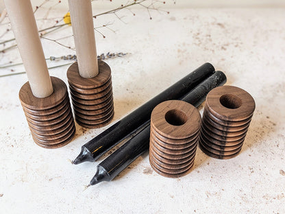 Two pairs of wooden candle holders in walnut with candles - top.